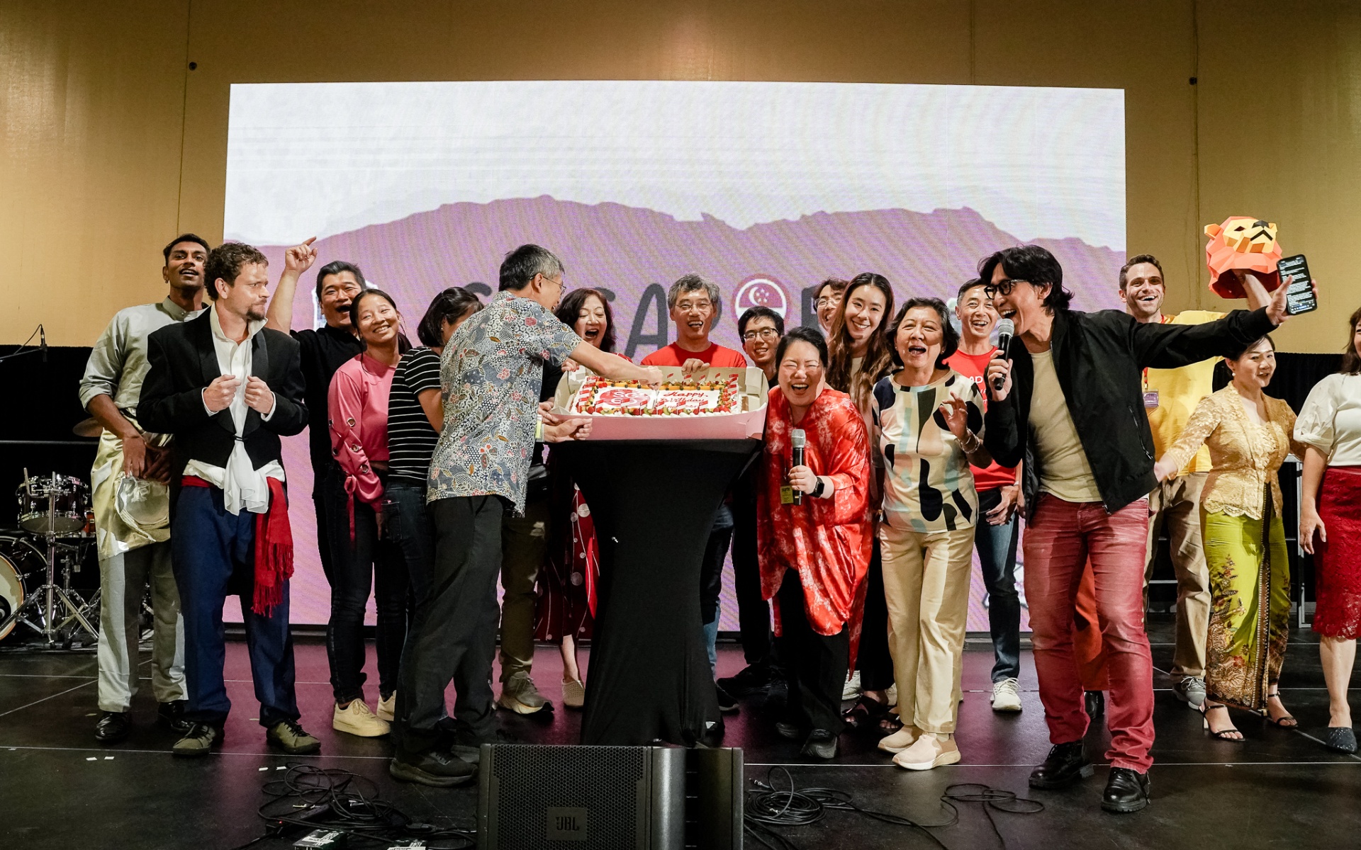 Group of festival organizers celebrating on stage
