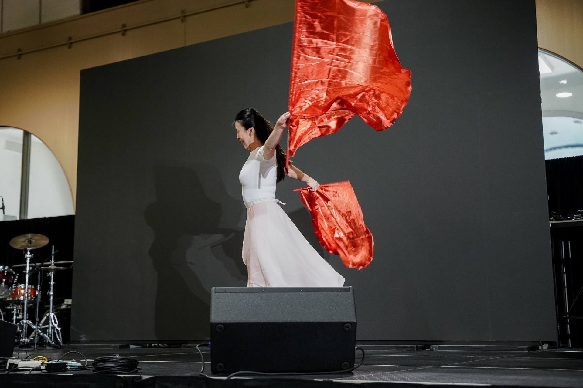 Dancer with red silk flags on stage